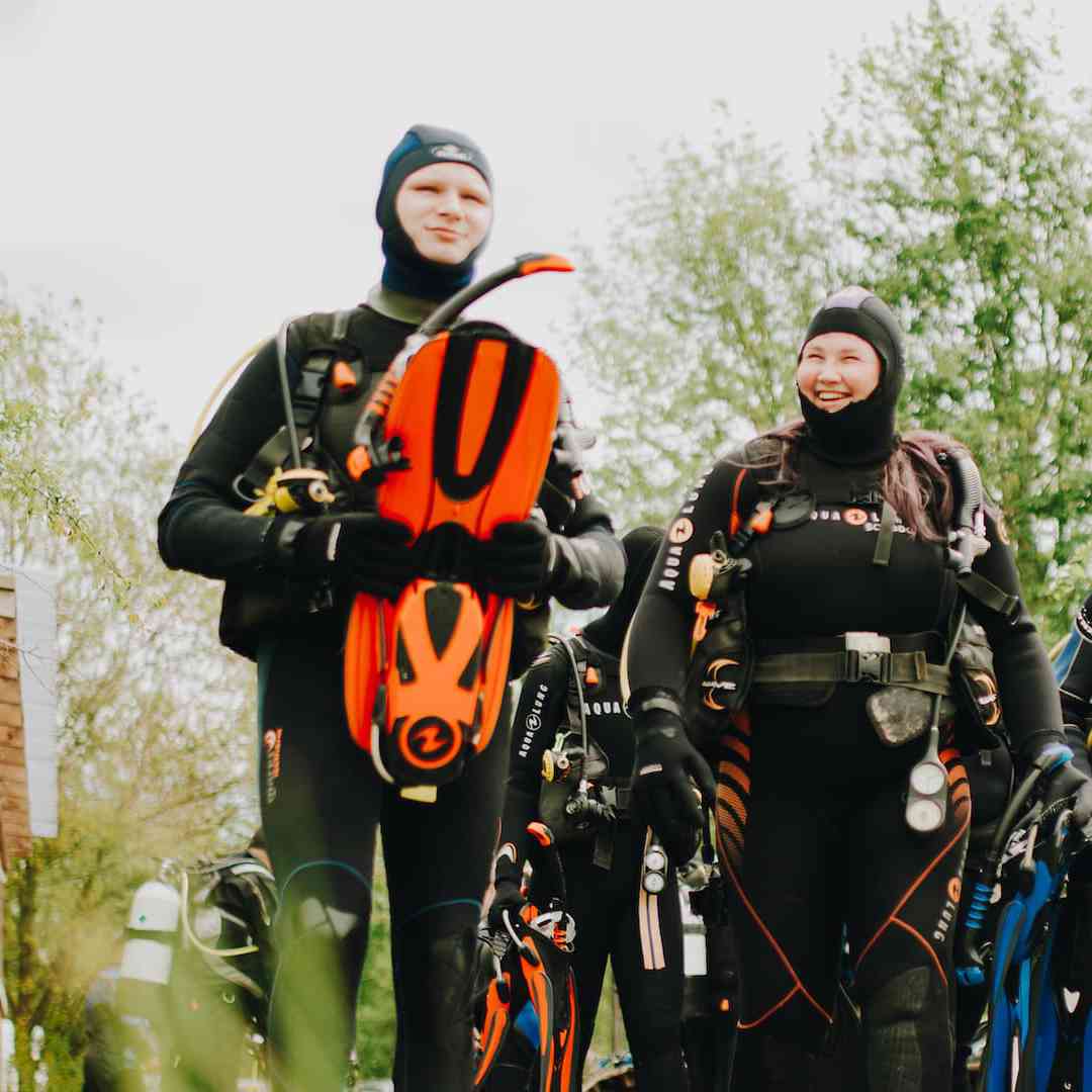 Marine Biology students wearing wetsuits take part in scuba diving course