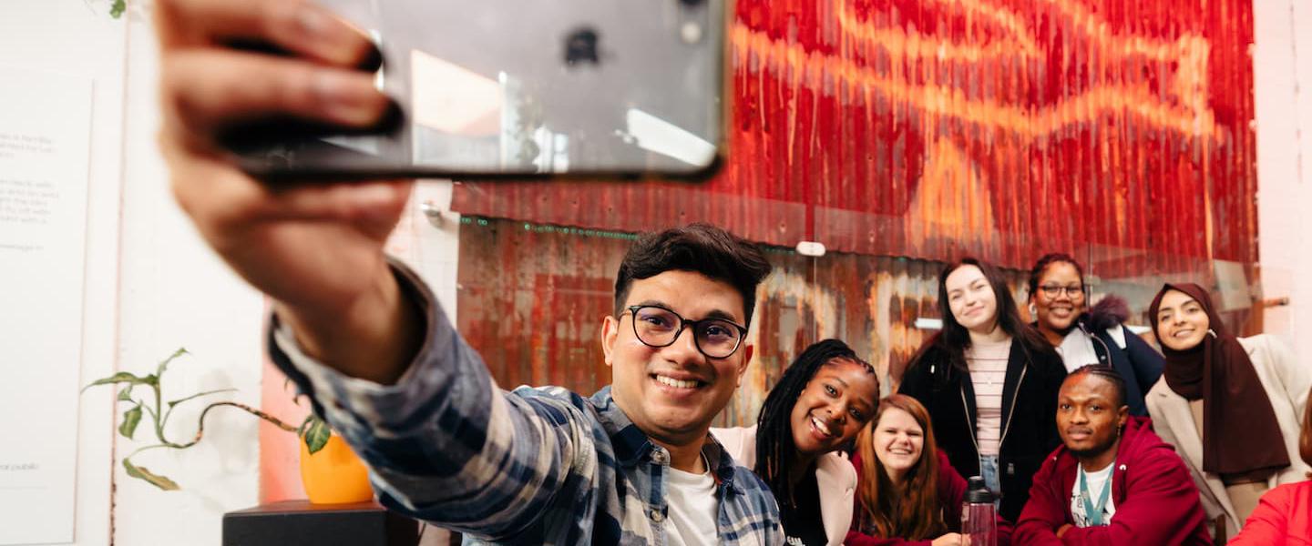 Students take a selfie in front of the Dead Bod artwork at Humber Street Gallery