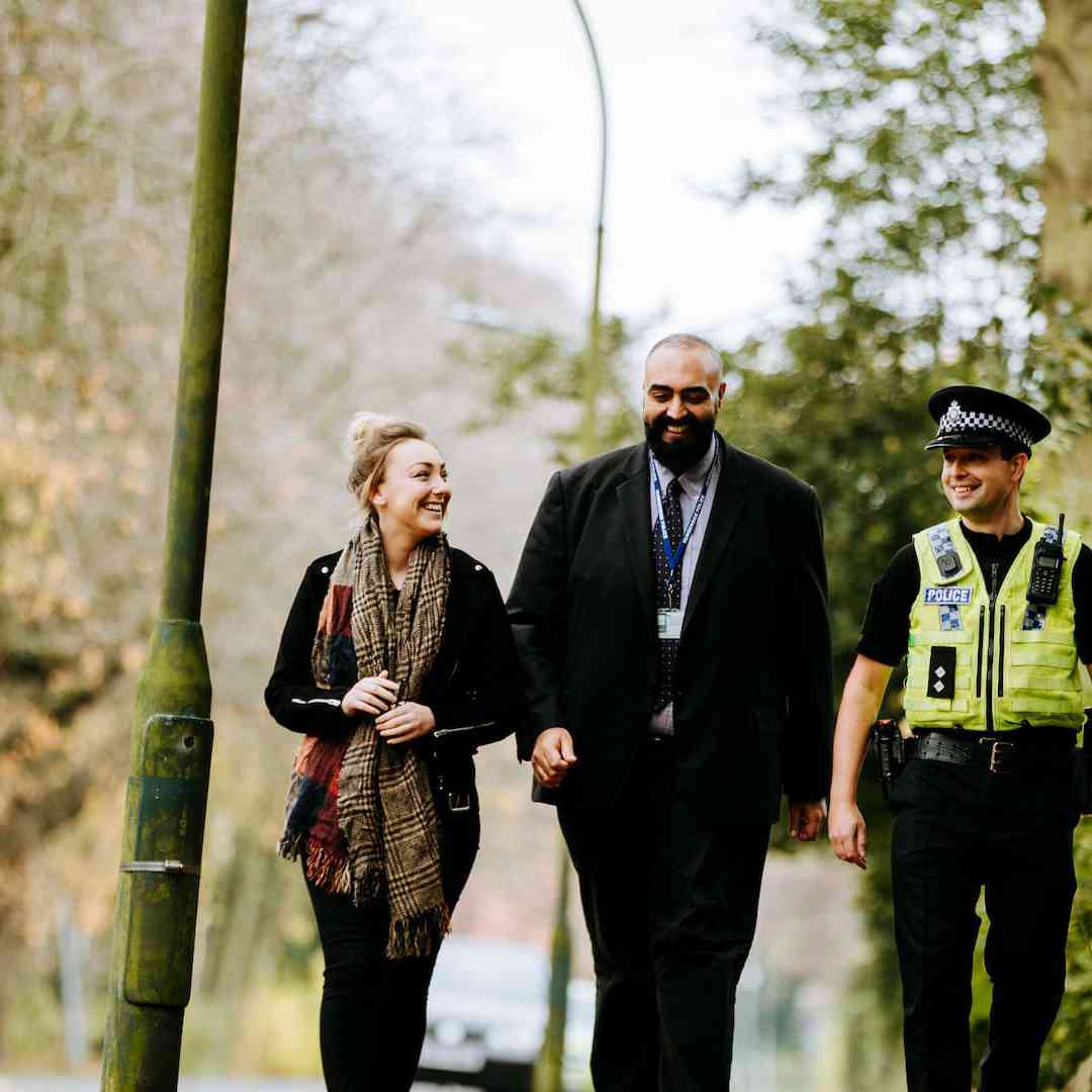 A criminology student walking down a path with two Humberside Police officers