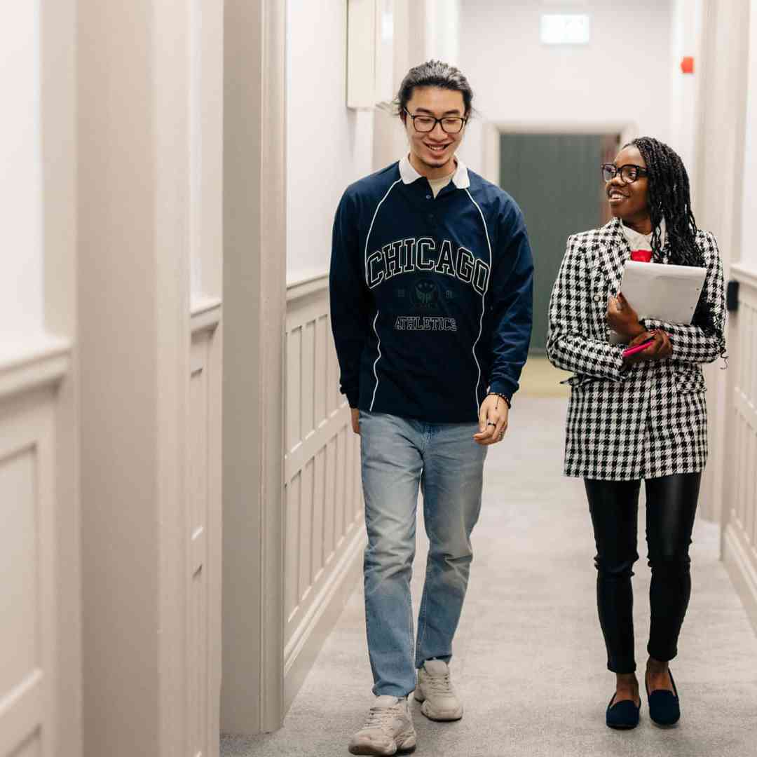 Two students walking down a corridor in the Legal Advice Centre