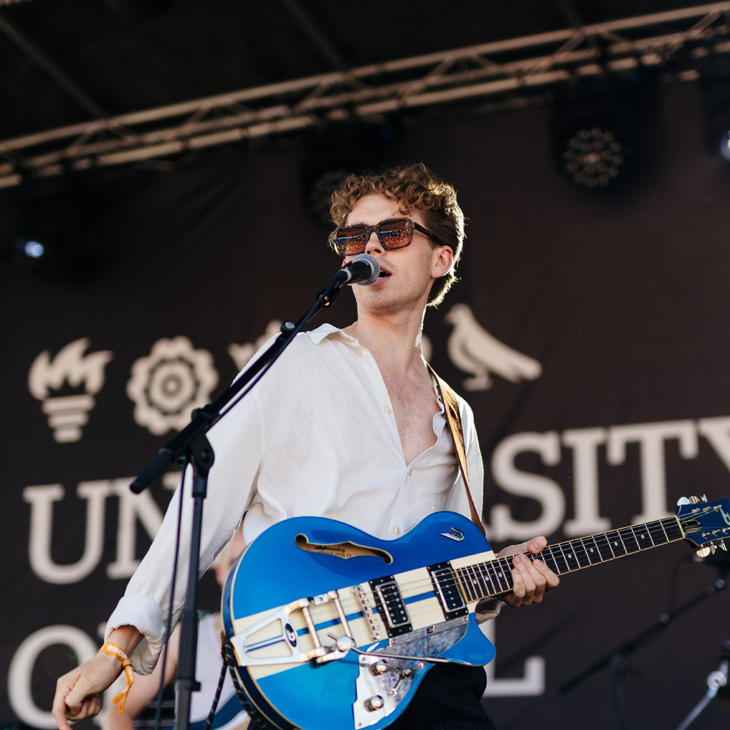 Lead singer with guitar performing on the University of Hull Main Stage at the Humber Street Sesh.