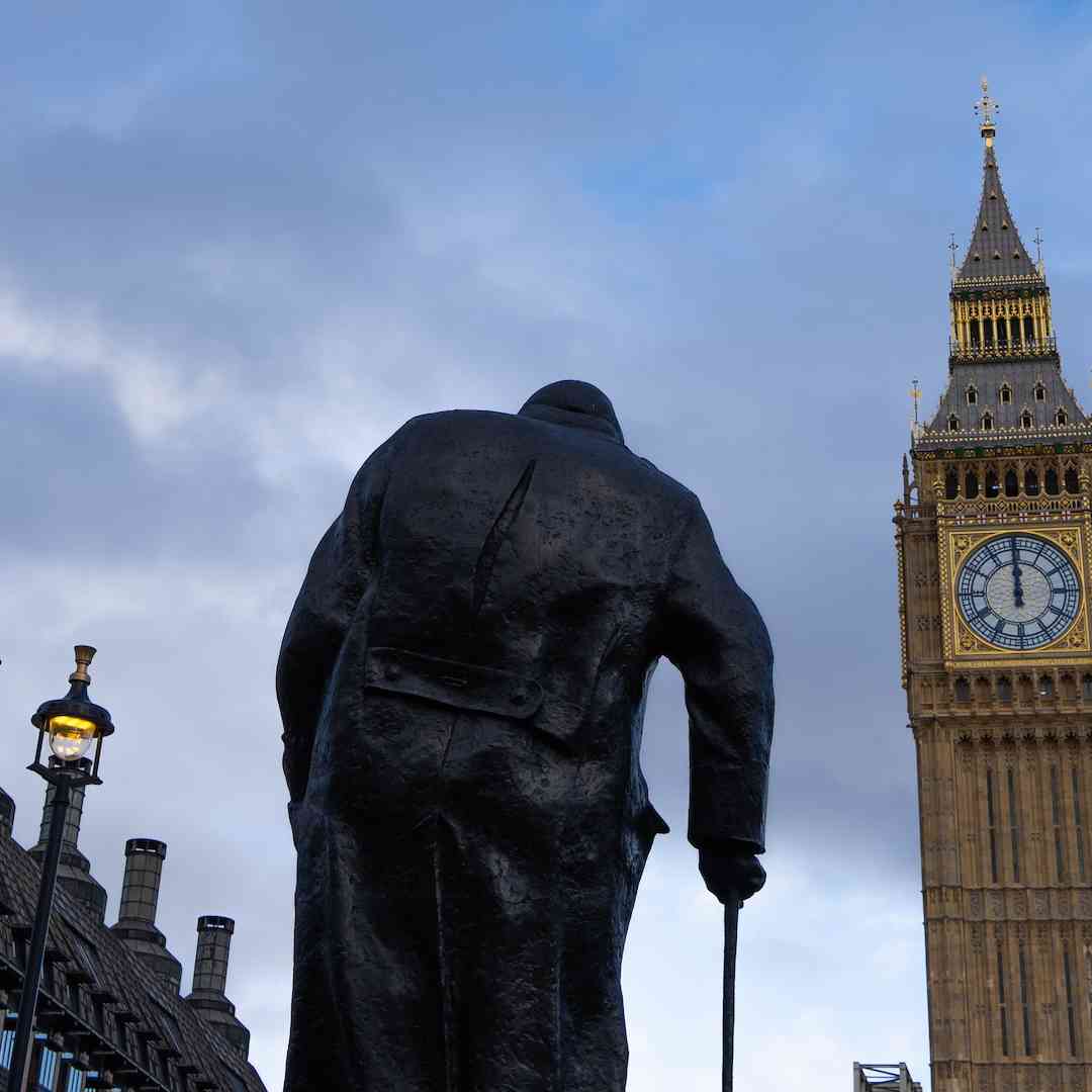 The statue of Winston Churchill in Parliament Square, London, with Big Ben nearby.