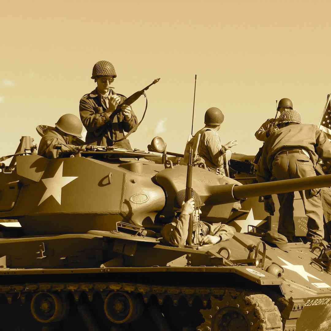 An old sepia photo of soldiers and tanks at war.