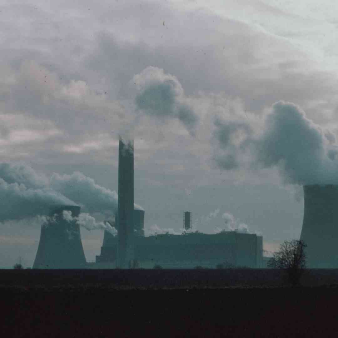 Smoke billows out of the chimneys of a power plant