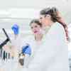 Two students examine the contents of a test tube in a laboratory