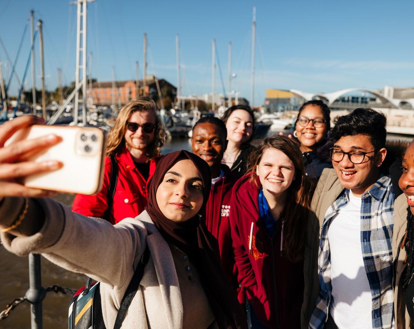 students taking a group selfie at the marina in hull