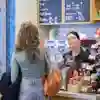 A student and her dad are served by one of our baristas at an on-campus cafe
