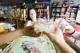 Four friends clink glasses of lemonade while playing Monopoly in a board games café