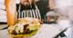 A chef at Dope Burger adds sauce as the finishing touch to one of their special gourmet burgers