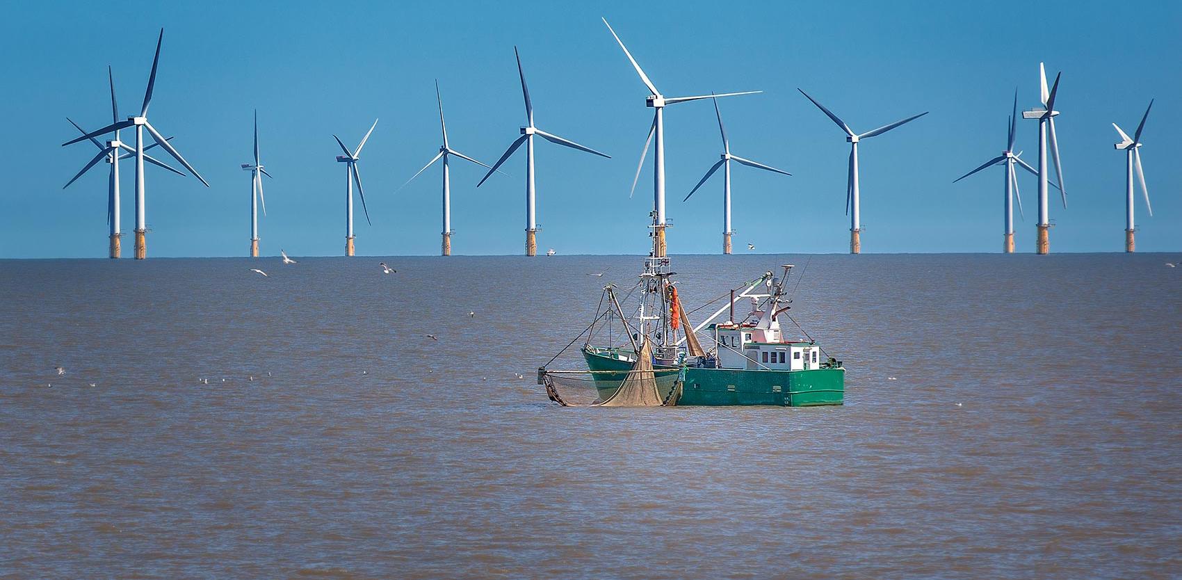 Ship in front of offshore wind farm