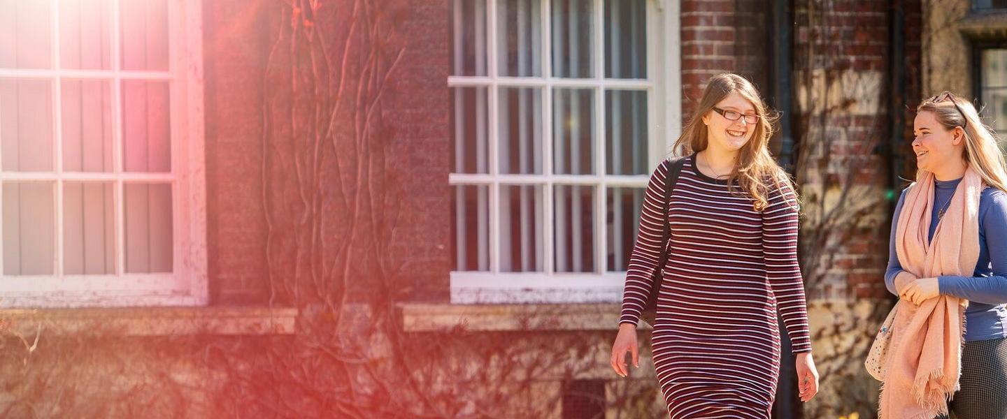 Postgraduate Rebecca Humphries & Georgia Sykes walking by HUBS Wharfe Building