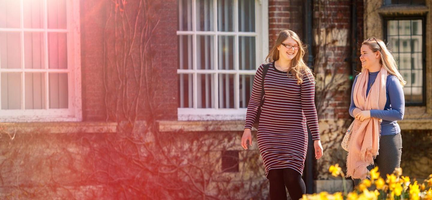 Postgraduate Rebecca Humphries & Georgia Sykes walking by HUBS Wharfe Building
