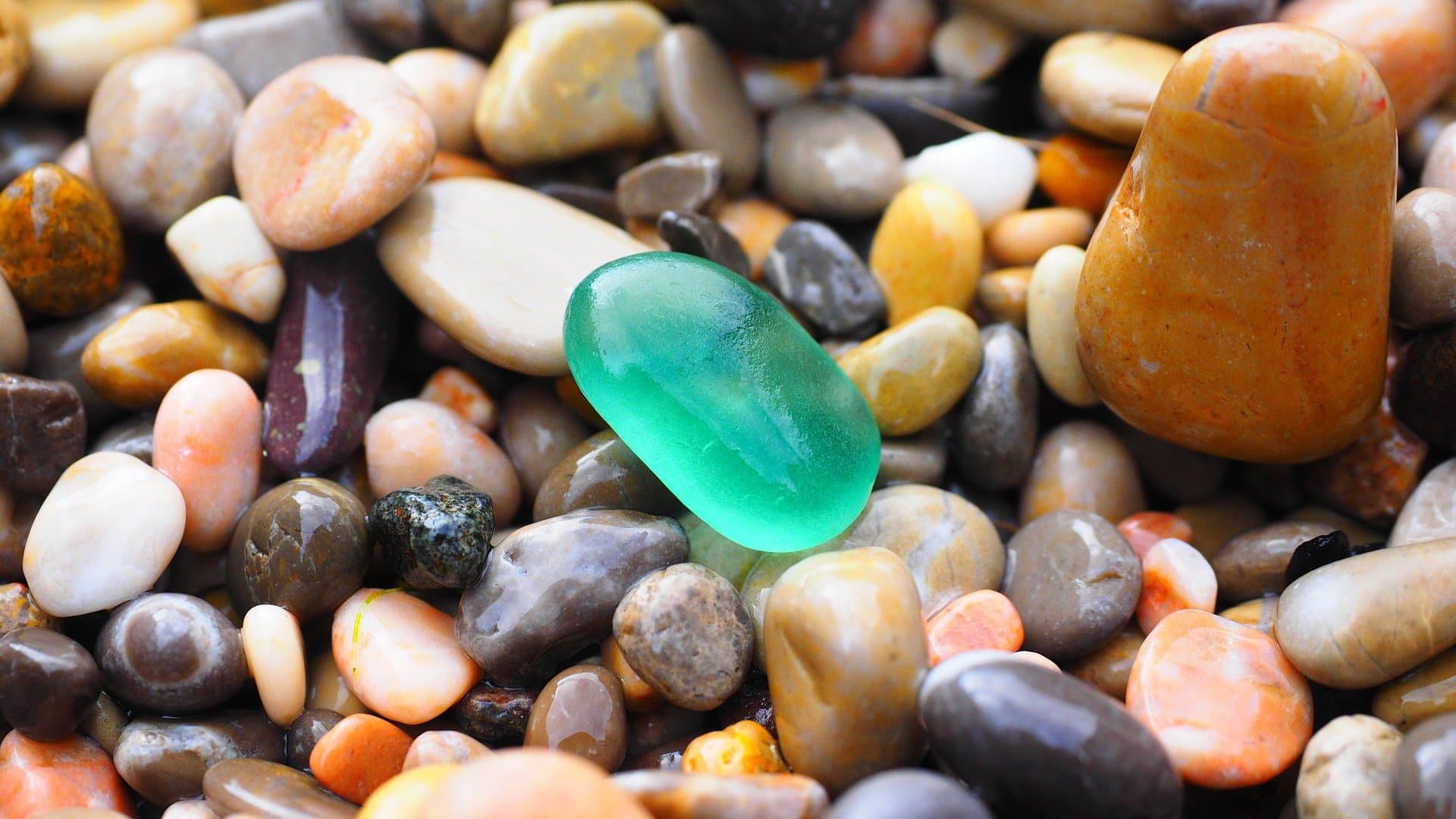 Multi coloured pebbles on a beach