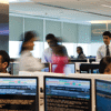 Stockbrokers move around at speed inside an office on a trading floor