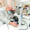 students using microscope in biology lab