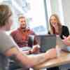 University of Hull graduates chat during a meeting at Summit Media's office
