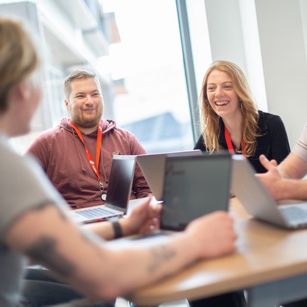 University of Hull graduates chat during a meeting at Summit Media's office