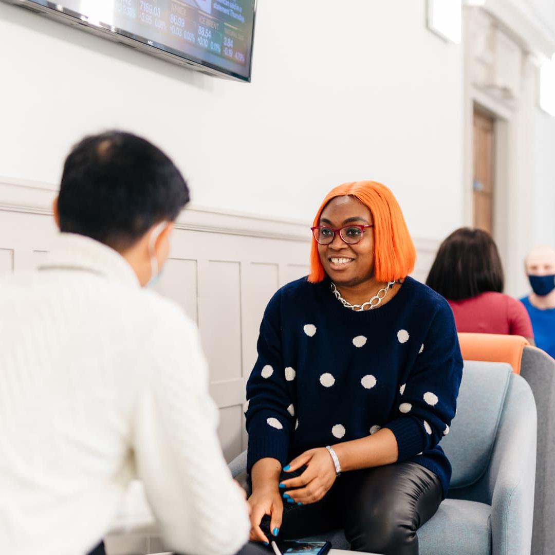 Students sat chatting in the Executive Education Suite