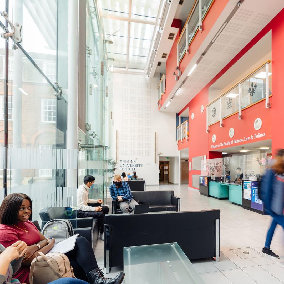 Business students walking through the foyer of the Nidd Building on campus