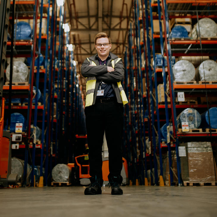 A University of Hull student stood wearing a high vis jacket while on placement at Siemens