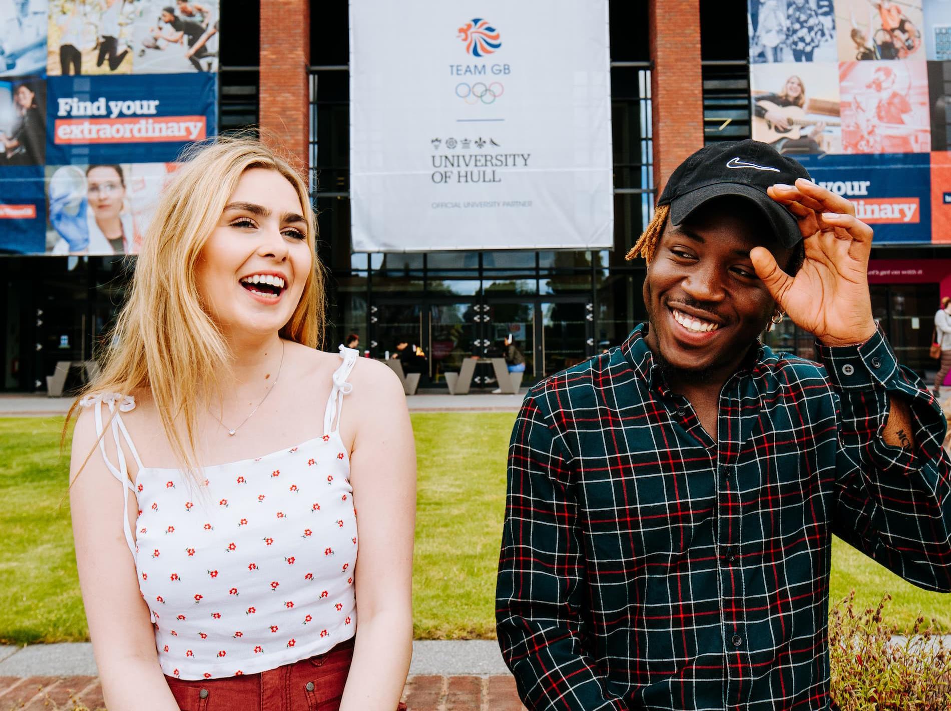 Two students sit outside the Brynmor Jones library