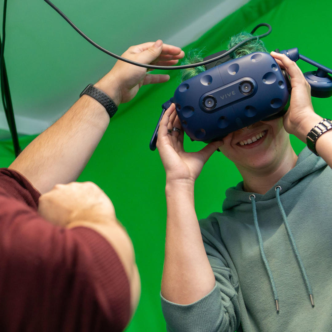 A student and lecturer with a VR headset in digital design studio