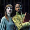 Two Hull Drama students in costume perform on stage. They are both looking off into the near distance.