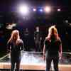 Two students standing on the stage in front of an audience at the gulbenkian theatre
