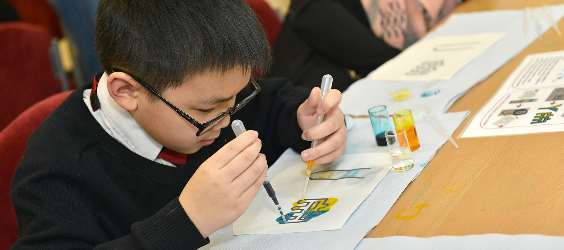 Primary school child taking part in lab on a chip activity