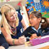 A PGCE teaching student working with two children on placement at Swanland Primary School