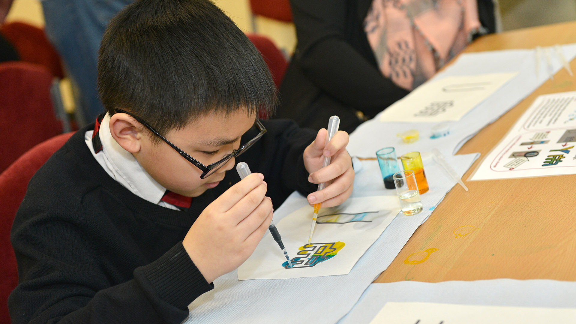 Primary school child taking part in lab on a chip activity