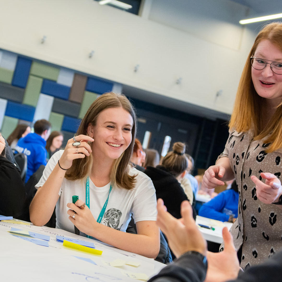 secondary students sat around a table in a marketing workshop