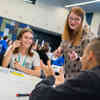 secondary students sat around a table in a marketing workshop
