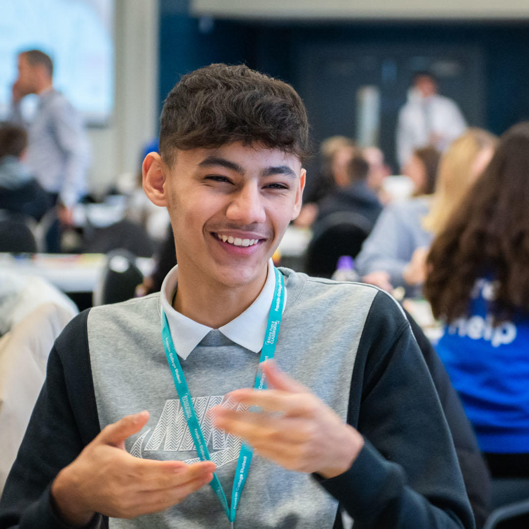 A secondary student sat at a table in a marketing workshop