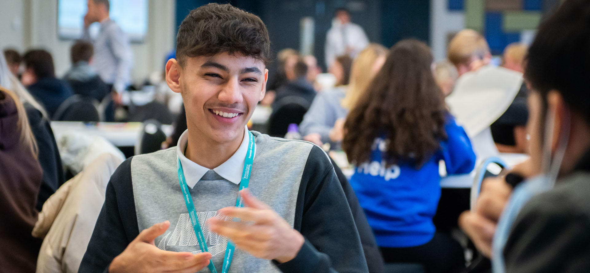 secondary student sat at a table in a marketing workshop