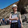 Hull student, Te'Jay, in hard hat stands holding a pen and notepad in the deserts of Almeria, southern Spain.