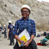 A student on Geology field trip, wears a heard hat at the base of a mountain in Almeria Spain 