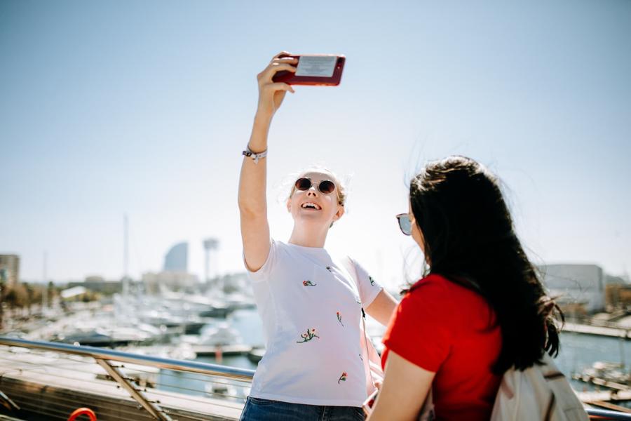 Millie North takes a photo at a marina in Barcelona during a Geography field trip