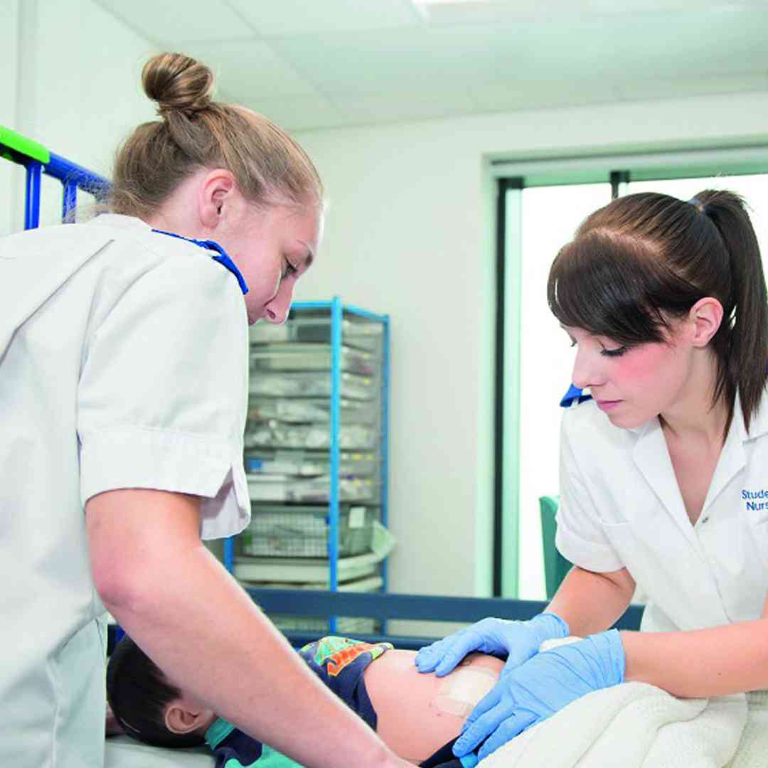 Two children's nursing students in the neonatal room