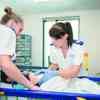 Two children's nursing students practise in the university's neonatal room