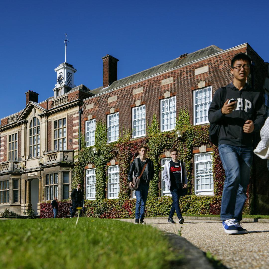 Students walk past the front of one of the University's grade 2 listed buildings