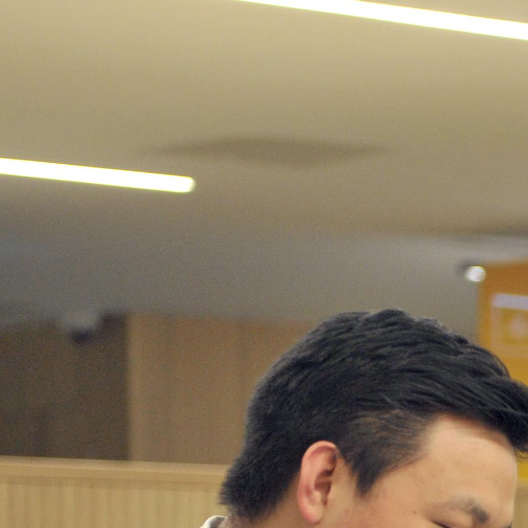 Two students laughing while working together in the library
