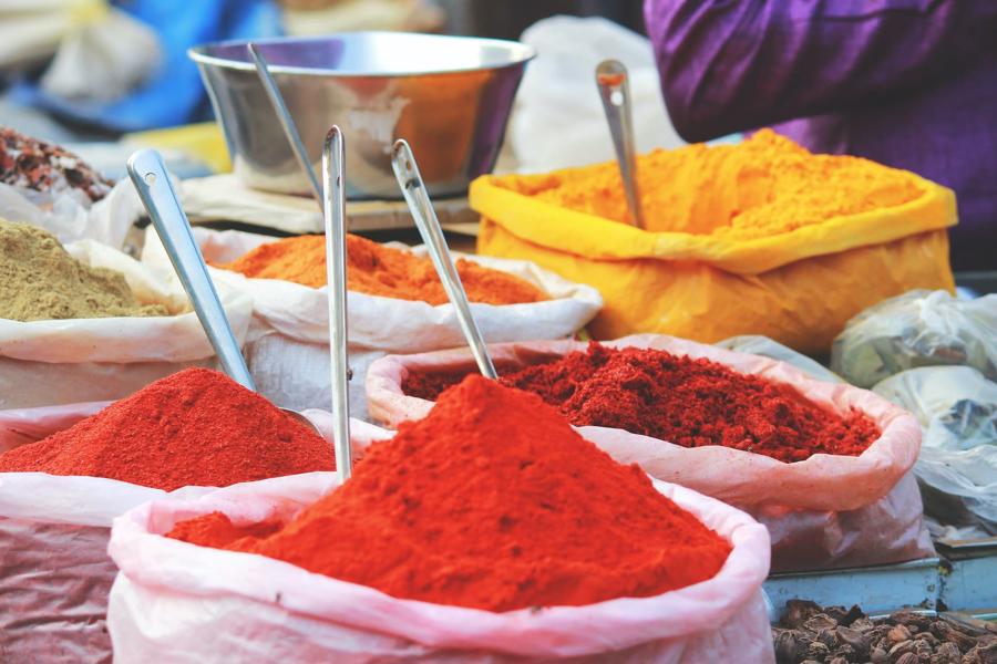 Bags of brightly coloured spices, on sale at a market in India