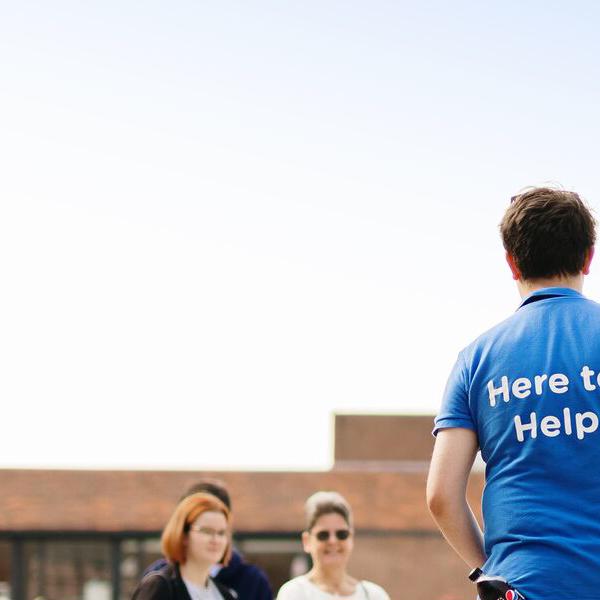 student ambassador stood with visitors on offer holder day