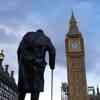 Statue of Winston Churchill in London with Big Ben nearby.