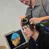 Hull Psychology student and lecturer using the brain monitoring equipment in the Brain Simulation Laboratory.