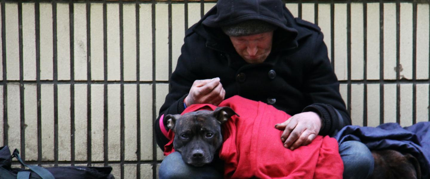 homeless man with dog on street