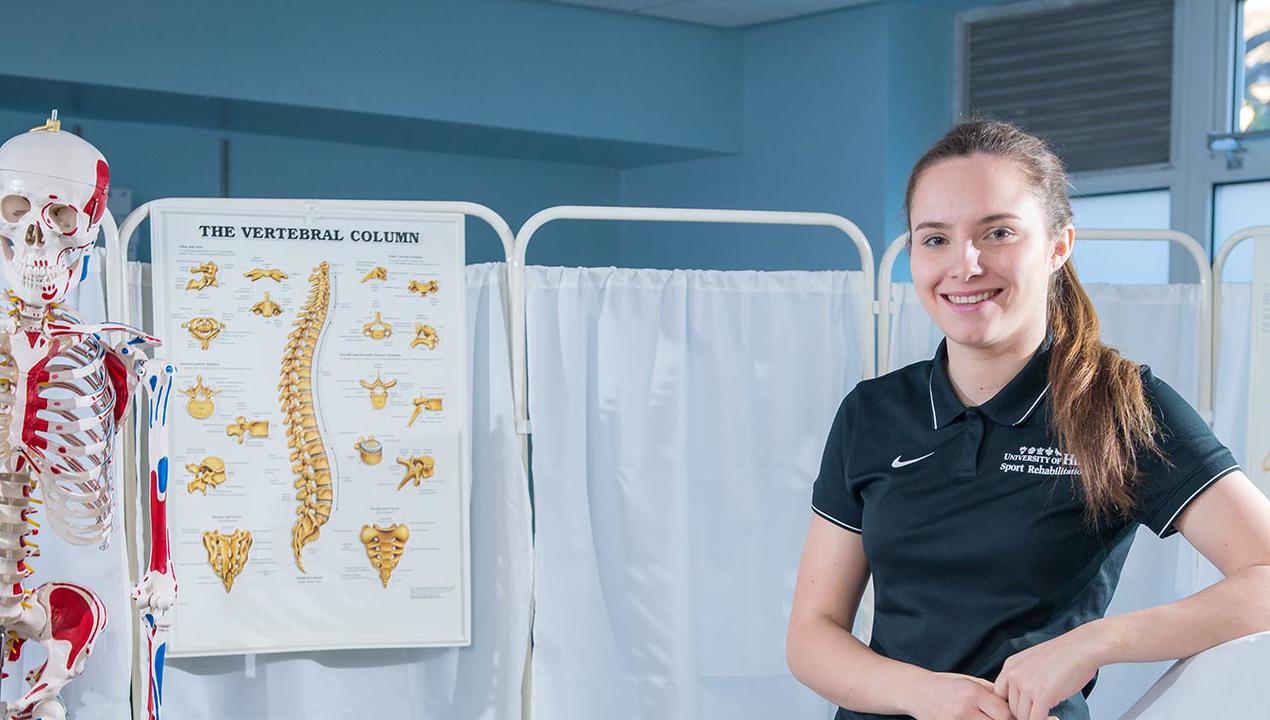 Sports rehabilitation student with skeleton diagram