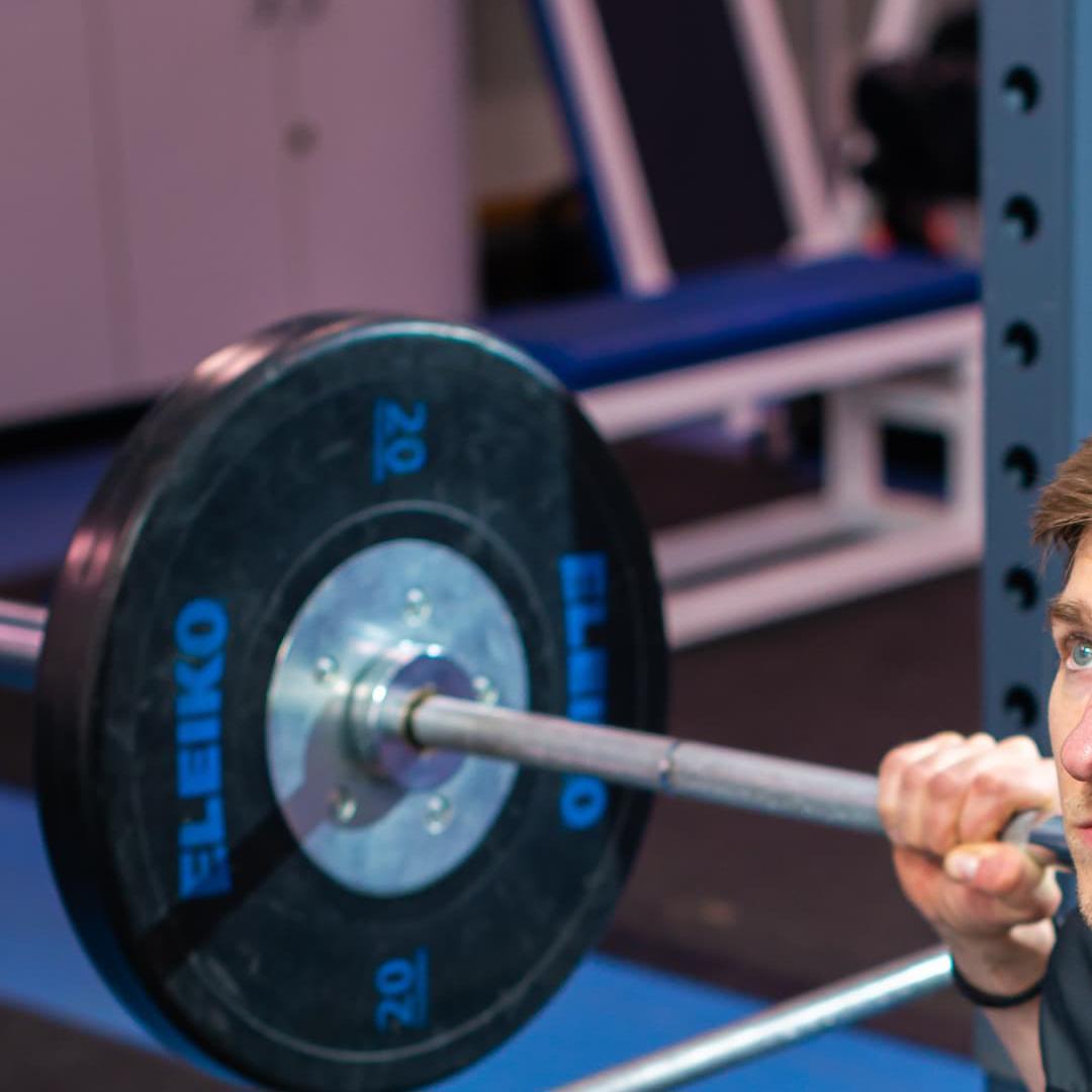 student lifting weights in biomechanics lab