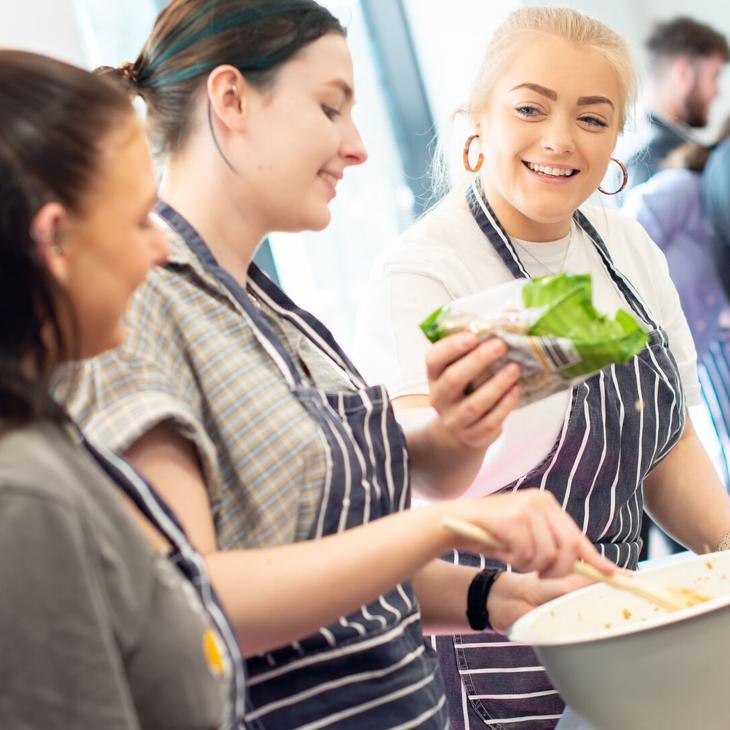 group of students cooking together during a nutrition workshop